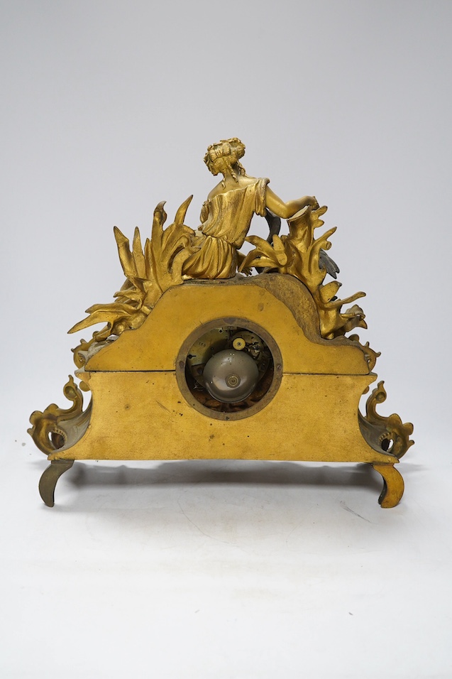 A Louis XV style gilt bronze mantel clock, 41cm wide, 35cm high. Condition - one replacement foot, fair but very dusty, not tested as working